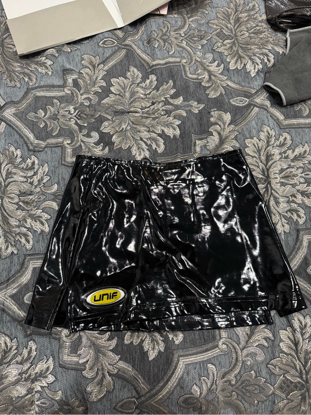 UNIF Black Patent Mini Skirt with Yellow Logo Patch